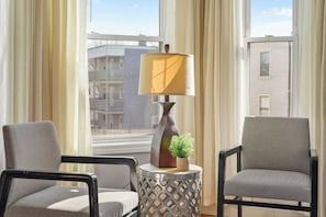 A room with two chairs, a lamp, and a potted plant on a side table. - 8BR Near Downtown Boston Private Driveway Parking & 1-Min Walk to Train (Boston)