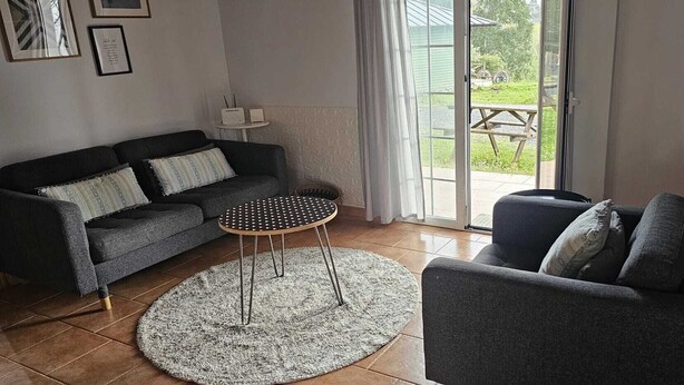 Ein Wohnzimmer mit einer Couch, einem runden Couchtisch und einem Kamin.