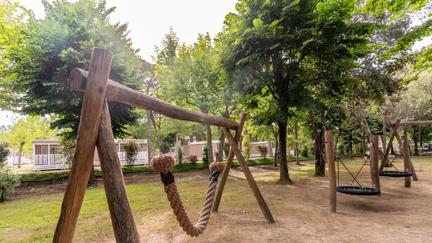 A playground with swings and a rope swing.