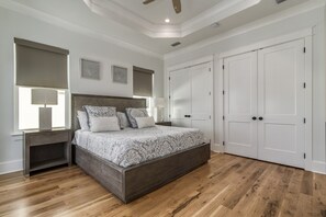 A bedroom with a bed, nightstands, a ceiling fan, and a wardrobe. - Luxury Home on 30A~ 5 min walk to beach~ 4 bikes! (santa rosa beach)