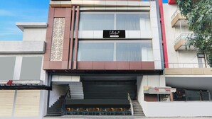 A modern building with a sign reading 'Collection' and a staircase leading to the entrance. - Classic With Balconyjr inn (Lucknow)