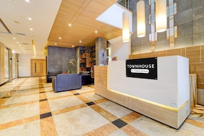 A reception area with a sign reading 'TOWNHOUSE Company Serviced.' - Townhouse Dindigul Rock Fort (Thindukkal)