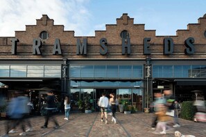A building with the sign 'TRAMSHEDS' above the entrance. - Light Filled Annandale Home (Annandale)