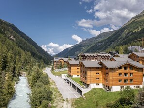 A mountain resort with wooden buildings, a river, and a clear sky. - SWISSPEAK Resorts Zinal by Interhome (Zinal)