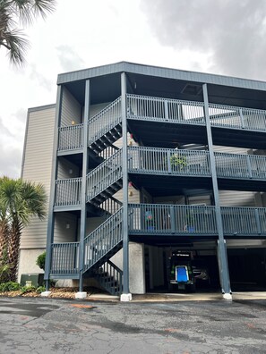 A multi-story parking garage with a metal staircase and railings. - Seaside Getaway (North Myrtle Beach)