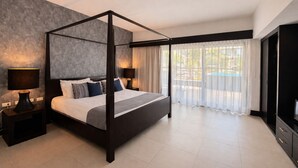 A modern bedroom with a four-poster bed, a large window with sheer curtains, and a view of an outdoor pool. - Master Suite with private Pool in Aldea Thai (Playa del Carmen)