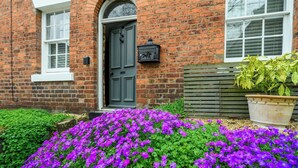 A brick house with a dark green door, white windows, and a mailbox. - Charming 2-Bed Townhouse with Parking, Near Centre - Pass the Keys (Shrewsbury)