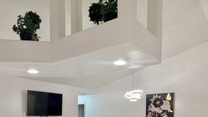 A modern kitchen with a central island, built-in appliances, and a dining area with a chandelier. - ☆☀︎❀Paradise! Pool Table, Sauna, Boat Parking, Fenced Yard, Near Boat Launch (Sebastian)