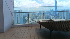 A balcony with a view of a cityscape, including a prominent tower. - KL Sentral, Kuala Lumpur, 4 pax Family Merdeka 118 Nice View, , Sky Pool MRT LRT (Kuala Lumpur)