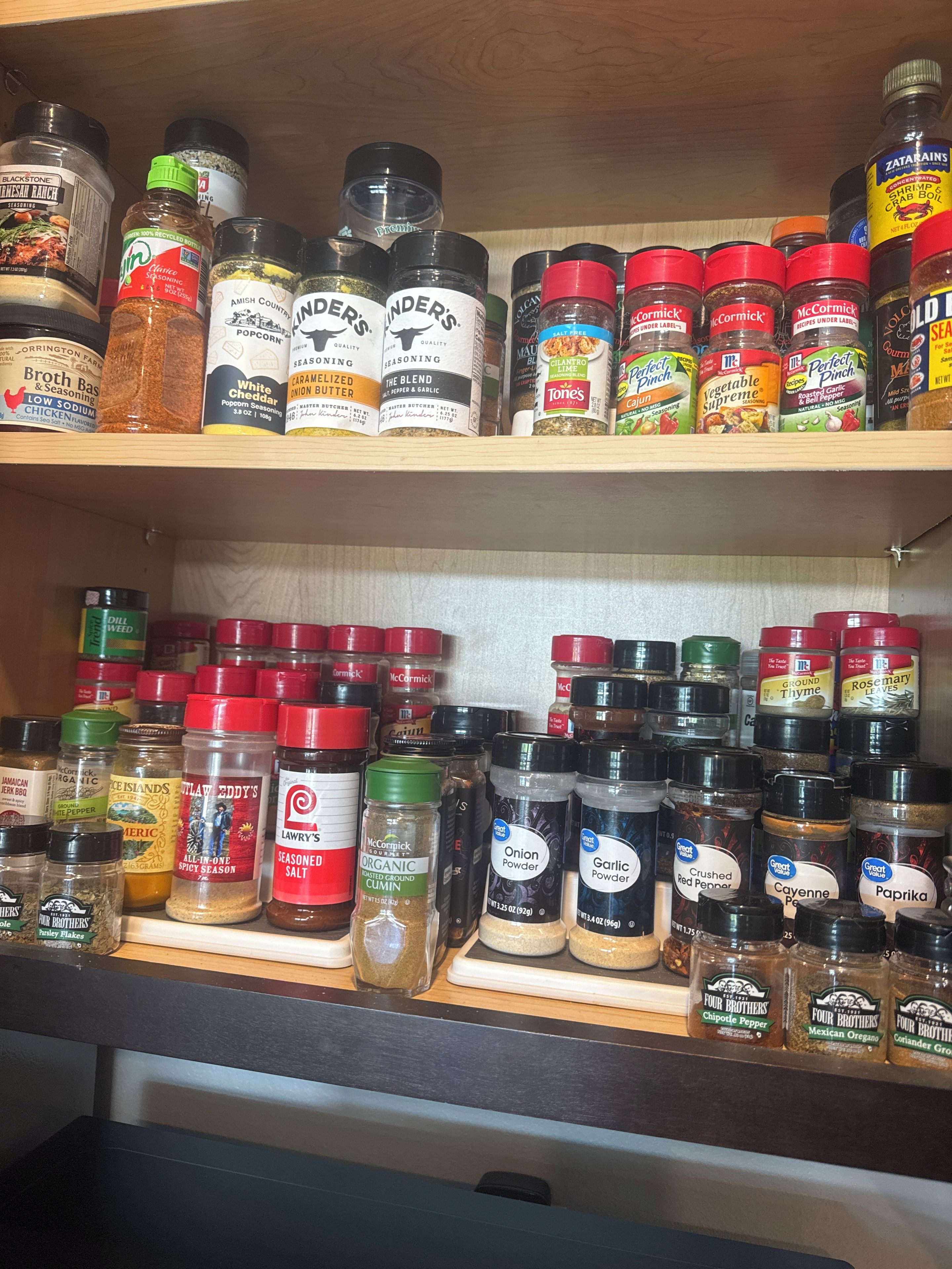 A spice rack with various seasoning jars.