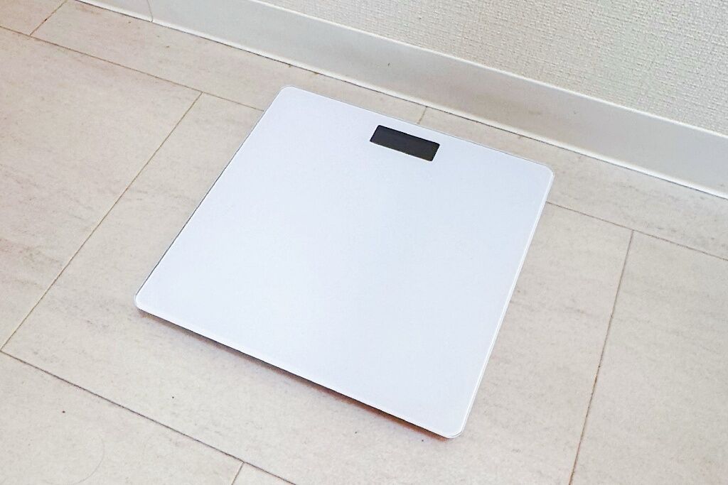 A white scale on a tiled floor.