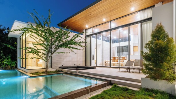 A modern house with a swimming pool, large windows, and a patio area. - New Prime Location Near Boat Avenue V306 (Choeng Thale)