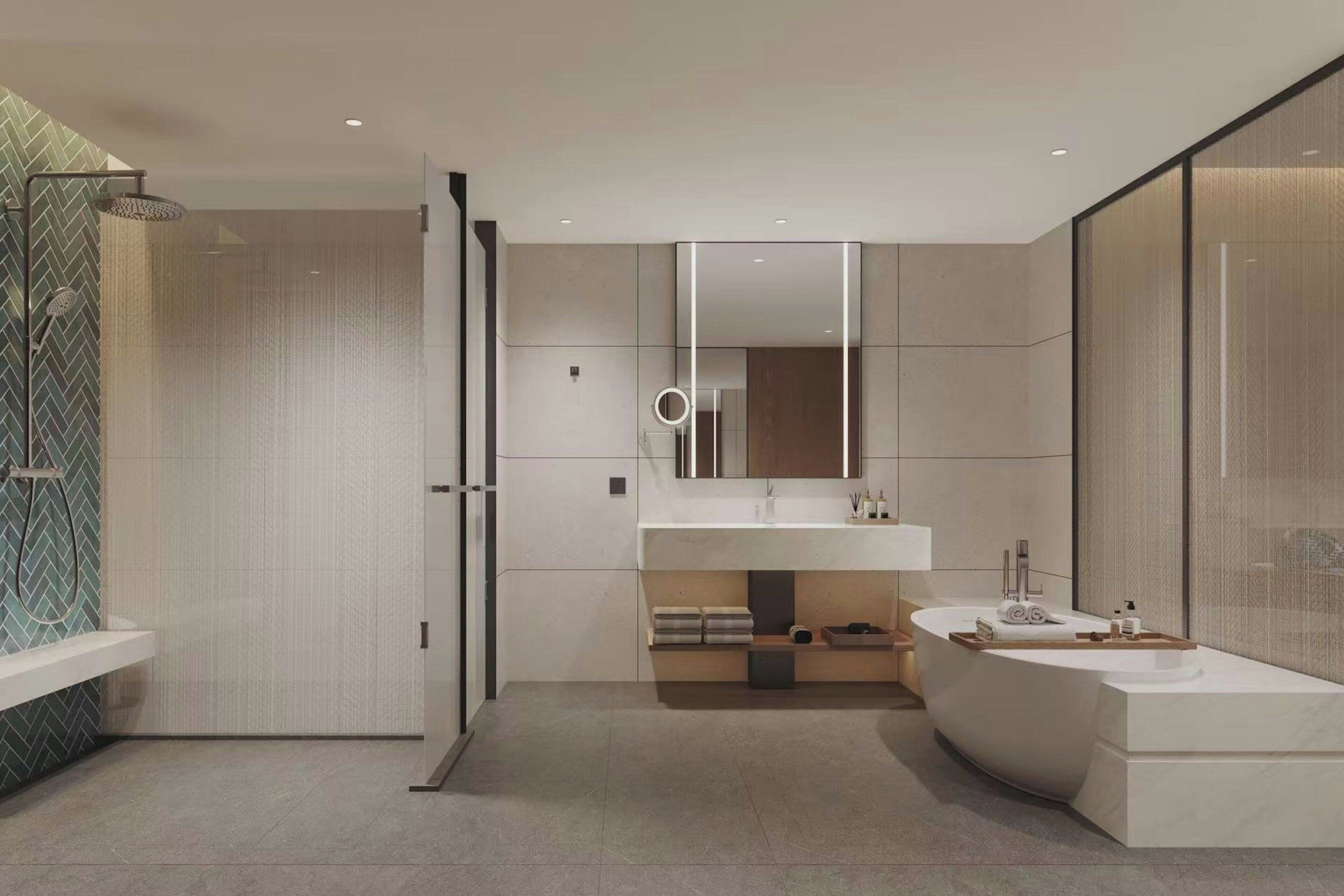 A modern bathroom with a freestanding bathtub, a large mirror, and a shower area.