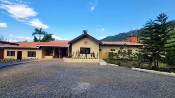 A building with a gravel driveway and a small garden area.