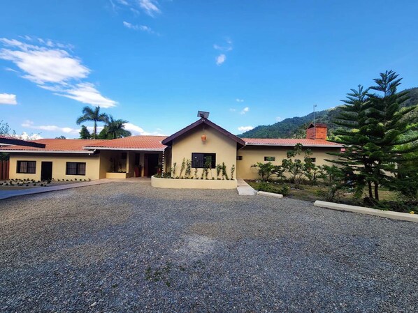 A building with a gravel driveway and a small garden area.