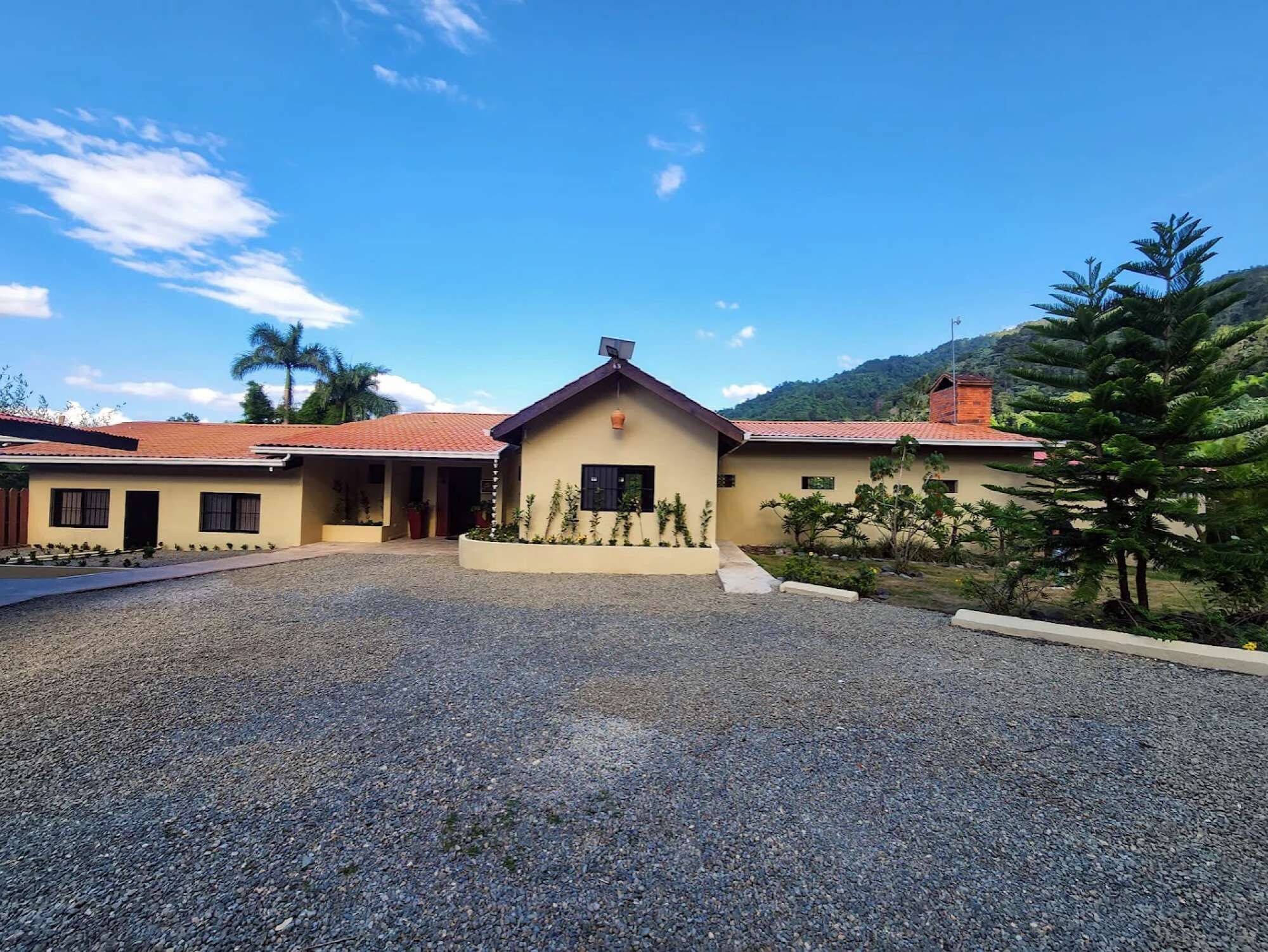 A building with a gravel driveway and a small garden area.