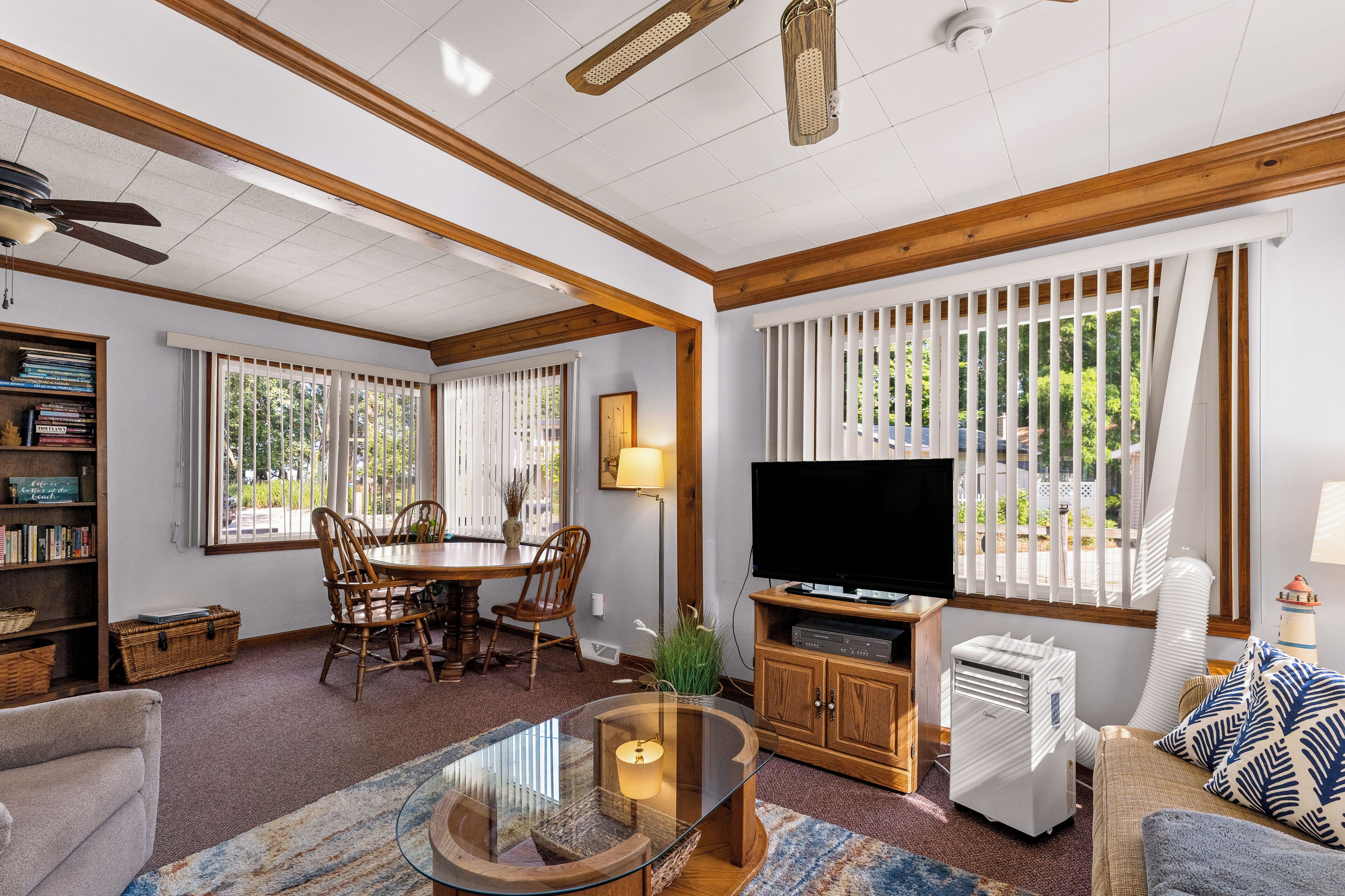 A spacious living room with a dining area, a television, and a fireplace.