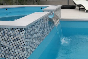 A swimming pool with a tiled edge and a lounge area with chairs. - Pool Apartment Sea 2, Privlaka, Croatia (Privlaka)