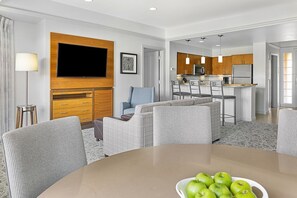 A modern hotel room with a living area, dining space, and kitchenette. - Marriott Desert Springs Villas II near Coachella (Palm Desert)