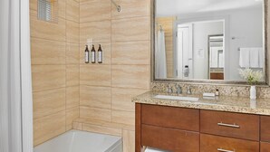 A modern bathroom with a shower, a bathtub, a large mirror, and a vanity with a sink. - Marriott Desert Springs Villas II near Coachella (Palm Desert)
