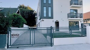 A modern two-story building with a white facade, two balconies, and a gated entrance. - USC Private Suite & Bath/Long-Term/Utilities, Wi-Fi & Laundry Incl. 4m to campus (Los Angeles)