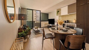 Una cocina moderna con comedor, televisor y vistas a la ciudad.
