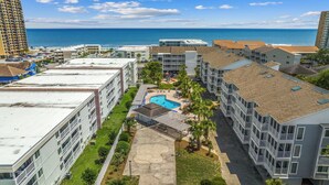 A resort with multiple buildings, a swimming pool, and a view of the ocean. - Shore Drive Gem: Walk to Beach, Pool & Apache Pier (Myrtle Beach)