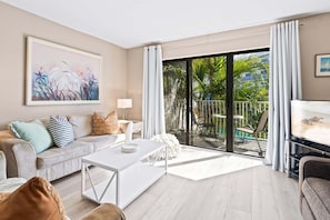 Two-Story Pool View Condo, Unit #206 | Living area | 50-inch TV with cable channels