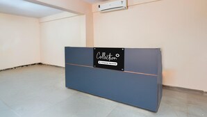 A reception desk with a sign that reads 'Collection' and 'Company-Serviced.' - Classic With Balcony LR Residency (Anekal)