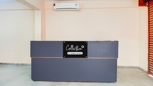A reception desk with a sign that reads 'Collection Company-Serviced.' - Classic With Balcony LR Residency (Anekal)