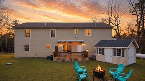 A two-story house with a deck, outdoor seating, and a fire pit. - Mount Pocono Escape • Firepit + Game Room • Near Trails + Lakes | Poconos Fun (Mount Pocono)