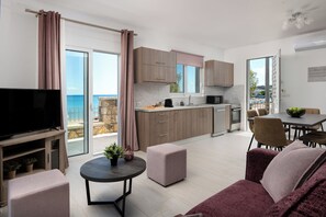 A modern apartment with a balcony, kitchen, dining area, and living room.