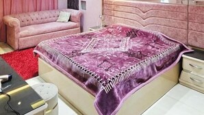 A bedroom with a bed, a sofa, a desk, and a dresser. - شقة فندقية لعشاق الذوق الرفيع Luxury Flat In Miami with panoramic sea views (Alexandria Governorate)