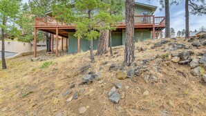 A house with a wooden deck, surrounded by pine trees and rocky terrain. - 1 Mi to Alto Lake! All-Season Base w/ Mtn Views (Alto)