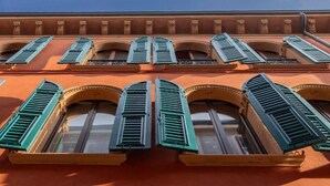 A building facade with multiple windows featuring green shutters, arched window designs, and a consistent architectural style. - PALAZZO TREZZA VERONA Preferred Hotels & Resorts (Verona)