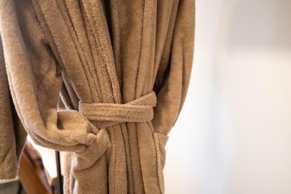 A brown robe tied around a chair.