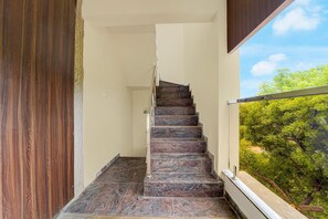 A staircase with a view of trees outside.