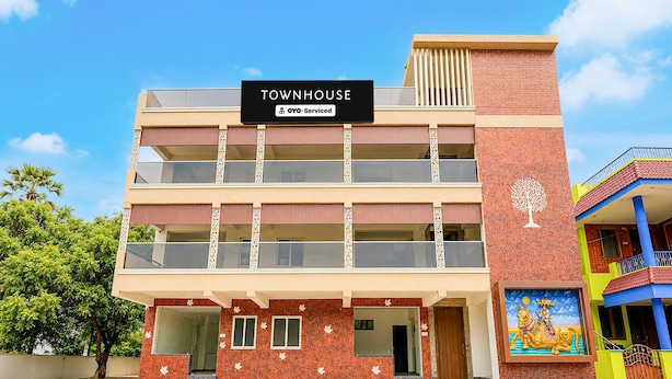 A multi-story building with a sign indicating it is serviced by OYO.