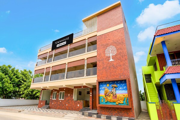 A multi-story building with a sign indicating it is a serviced apartment.
