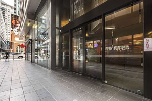 A modern building with large glass windows and a sign for 'Fifth Apartments'. - 2B2B 173m2 Huge Private Terrace Pool Sauna/Steam Spa Room Gym FREE Parking (Melbourne)