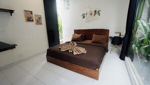 Un dormitorio con una cama de madera, una silla negra y una ventana con plantas.