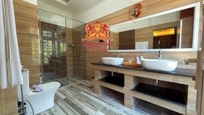 A modern bathroom with a glass shower enclosure, dual sinks, and a large mirror. - Kingswood Tea Factory (Ramboda)