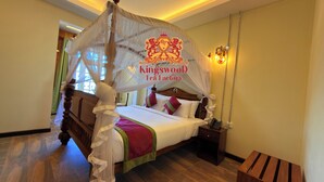 A bedroom with a canopy bed, a bedside phone, and a nightstand. - Kingswood Tea Factory (Ramboda)