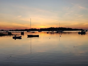 A calm body of water with boats and a pier. - No crowds after Labor Day Week on Cape Cod  at Old Silver Beach (Falmouth)