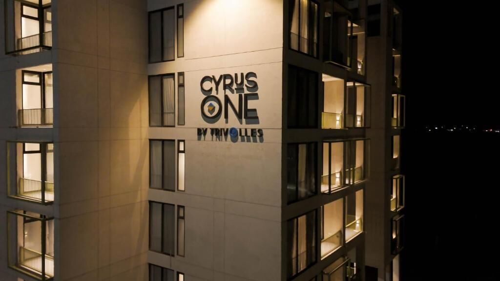 A building with multiple windows and a sign that reads 'CYRUS ONE BY TRIVOLLES'.