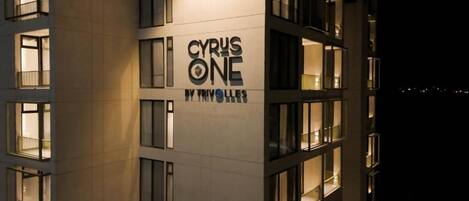 A building with multiple windows and a sign that reads 'CYRUS ONE BY TRIVOLLES'.