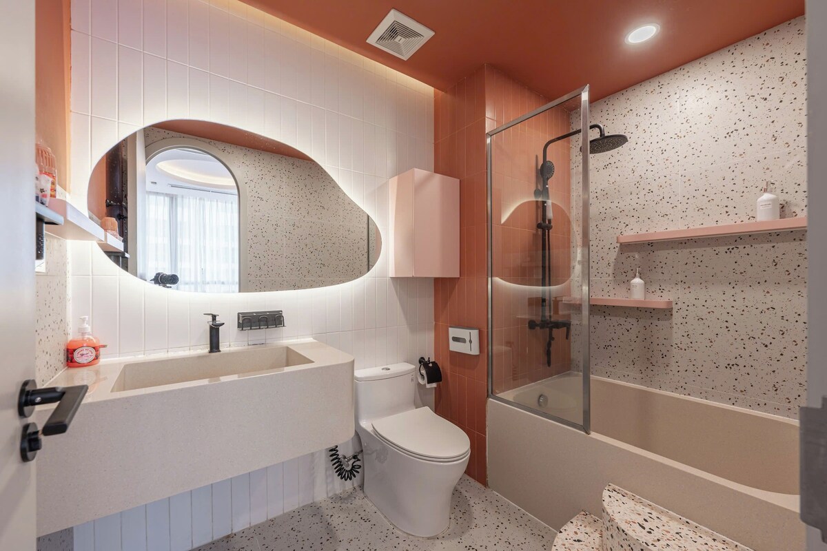 A modern bathroom with a freestanding bathtub, a toilet, and a sink.