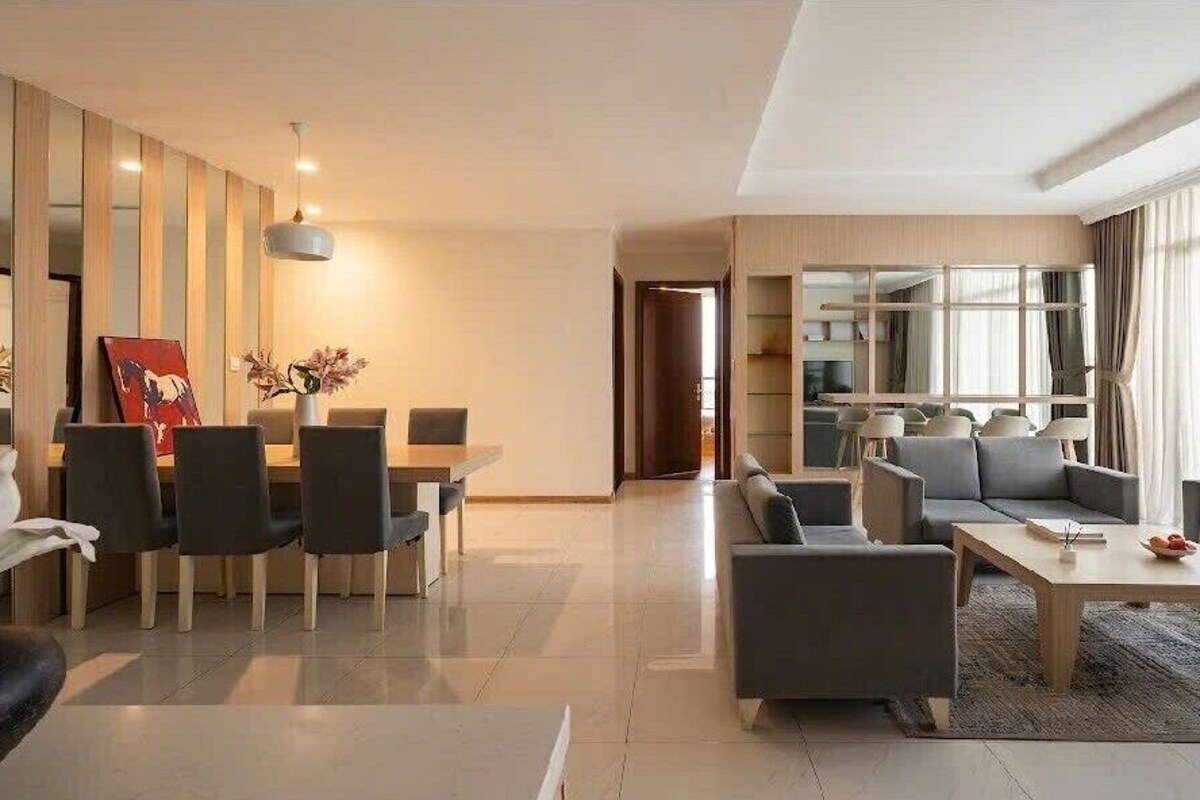 A modern living room with a dining area, a sofa set, and a coffee table.