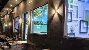 A construction site with exposed concrete walls, large windows, and construction materials. - Amrit Hotel & Resort (Thanagazi)
