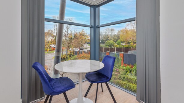 A room with a large window, two chairs, and a round table. - Beautiful 1-bedroom apartment in the heart of Birmingham (Birmingham)